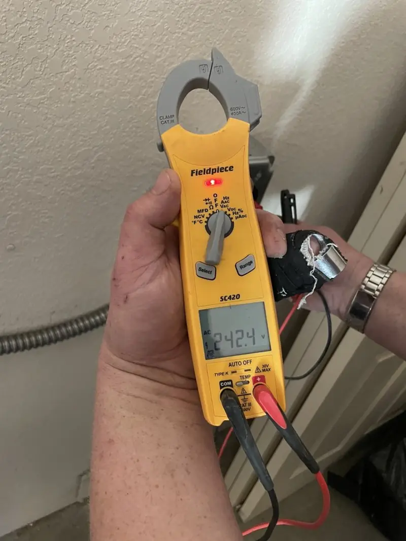 Voltage testing with clamp meter during Outlet Installation in Montrose